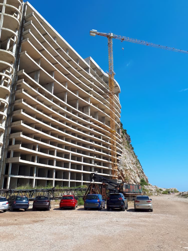 Multi-story building under construction with tower crane